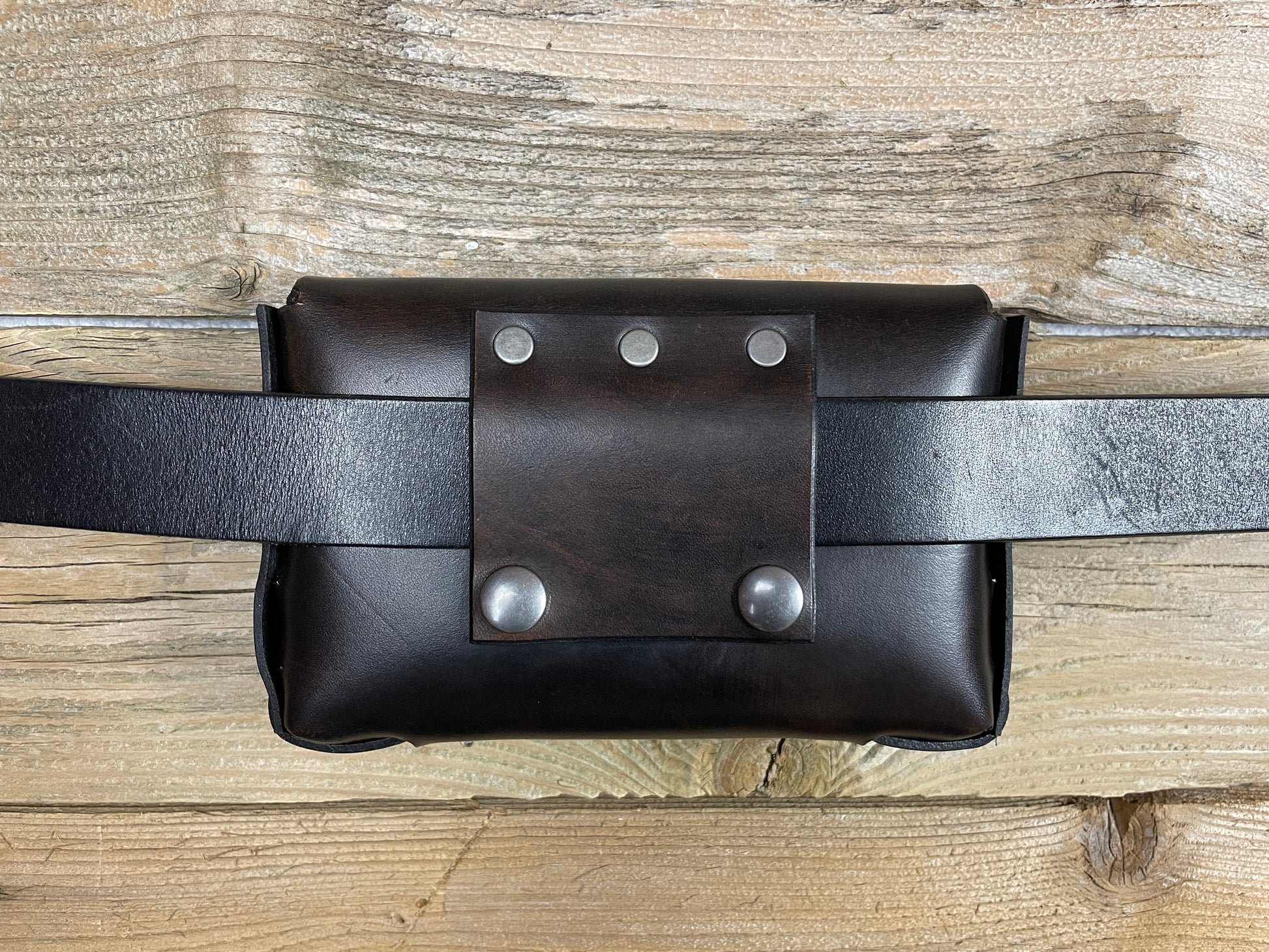 On the back side is the belt clip. You can either slide your own belt through or use the snaps to secure.
